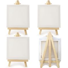 three wooden eases with white canvases on them