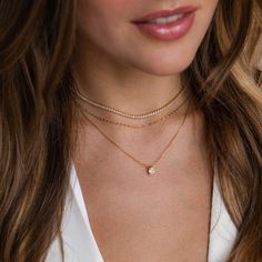 Our Diamond Tennis Choker Necklace is the only thing you will want to accessorize with. The glimmer of the diamond gemstones and the daintiness of the chain put you in the spotlight, when you want to be. Wear this beautiful necklace while running errands or on date night; either way, you will be sure to stand out. SKU: RR-NR152 Product Details Finish/Material: 18K Gold Over Brass ∙ Rhodium Over Brass, CZ Diamond Gemstones Featuring a Dainty ~2mm CZ Diamond Tennis Choker Necklace, available in 2 Delicate Everyday Charm Choker Necklace, Delicate Everyday Charm Necklace Choker, Delicate Charm Choker Necklace For Everyday, Dainty Everyday Birthstone Necklace With Delicate Chain, Delicate White Diamond Necklace For Everyday, Delicate Everyday Choker Jewelry, Minimalist Tiny Charm Necklaces For Anniversary, Tiny Minimalist Charm Necklace For Anniversary, Minimalist Tiny Charm Necklace For Anniversary