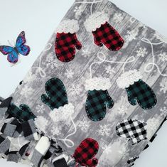 a close up of a piece of cloth with different designs on it and a butterfly next to it