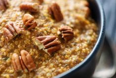 a bowl filled with oatmeal topped with pecans