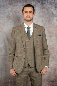 As worn by West Ham United goalkeeper Lukasz Fabianski! This Ted suit offers a sophisticated take on English gent-style, crafted with a traditional herringbone wool-mix cloth in earth-toned hues. The multi-tonal check pattern invokes 19th century tweed yet the contemporary colour accents make it ideal for any 21st century wardrobe. Matching children's suit available. Features Herringbone Slim fit Single-breasted Notch lapel Single back vent Four button cuff Double button blazer fastening Complim Formal Tweed Jacket With Herringbone Pattern, Tailored Herringbone Tweed Jacket In Timeless Style, Brown Tweed Suit With Herringbone Pattern, Tailored Timeless Tweed Jacket With Herringbone Pattern, Herringbone Tweed Jacket For Business, Winter Tweed Three-piece Business Suit, Winter Business Tweed Three-piece Suit, Winter Tweed Three-piece Suit For Business, Tweed Herringbone Suit For Tailoring