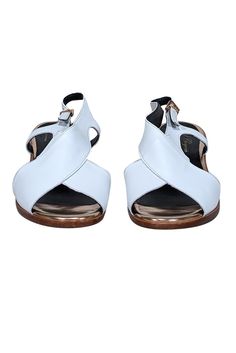 Step into summer with these stylish Robert Clergerie white leather sandals accented with reflective rose gold heels and trim. A versatile staple for any wardrobe, pair it with linen crop pants and a knit top for a chic summer look. Size 8 (FR 38.5) Made in France Leather upper Buckle ankle closure Rose gold trim and heel Heel height 2" Rose Gold Heels, Leather Rose, White Leather Sandals, Robert Clergerie, Cropped Linen Pants, Linen Crops, Gold Heels, Crop Pants, Summer Look