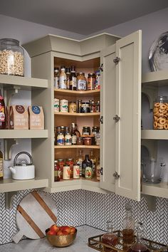 an open cabinet in the corner of a kitchen