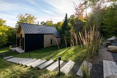 a small cabin in the woods with steps leading up to it