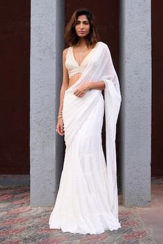 Ivory tired pre-draped saree with scattering sequin embroidery all over and pearl beaded border. Paired with pearl and beads embroidered blouse. - Aza Fashions Elegant V-neck Georgette Pre-draped Saree, Elegant V-neck Pre-draped Georgette Saree, White Pre-draped Saree With Sheer Dupatta, White Draped Pre-draped Saree For Wedding, Elegant White Draped Saree, Elegant White Pre-draped Saree With Traditional Drape, Elegant White Pre-draped Saree In Traditional Style, White Floor-length Pre-draped Saree, Draped Saree