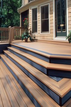 Inviting outdoor deck with warm two-tone staining and vibrant plant accents. Two Color Deck Ideas, Two Tone Deck Stain Ideas Color Schemes, Two Tone Deck, Deck Stain Ideas, Deck Paint Colors, Cottage Landscaping, Wood Deck Railing, Two Level Deck, Deck Stain Colors