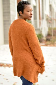 Add this rust colored cardigan to any ensemble for a nice cozy feeling. Two Pockets Model is wearing a Small Brown V-neck Cardigan For Layering, Orange V-neck Knit Sweater, Brown Knit V-neck Outerwear, Brown Knitted Cardigan For Fall, Brown Textured Knit Cardigan For Layering, Brown Knit V-neck Sweater With Long Sleeves, Cozy Brown Knit V-neck Sweater, Brown Knit V-neck Long Sleeve Sweater, Brown V-neck Knitted Cardigan