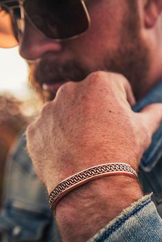 The Boynton Canyon Copper Cuff Bracelet is made to represent the red rocks of the West. The copper pattern in the center of the cuff gives the impression that the two lines of metal are interlocking with each other and are repeated throughout the entirety of the cuff. The center design is surrounded by a smooth copper edge creating a finished look. One size fits most. Mens Two Toned Cuff Bracelets, Cuff Bracelets For Men, Copper Bracelet For Men, Western Cuff Bracelet, Copper Jewelry Diy, Mens Copper Bracelet, Mens Cuff Bracelets, Jewelry Box Design, Bracelet Inspo