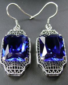 "Simulated Blue Sapphire Earrings Lantern Design#E13 Custom Made Inspired by the Art Deco movement of the early 1900s, I now offer these lovely Antique reproduction earrings in sterling silver. These earrings were refashioned from an Antique Art Deco brooch. Each stunning 9ct Simulated Blue Sapphire is 15mm long (just over 9/16\") and 12mm in width (1/2th\"). The earrings are 1 3/4th inch long and 9/16th at their widest. I often also sell the matching pendant. A gift box is included and all item Classic Formal Earrings With Rectangular Stone, Classic Rectangular Party Earrings, Classic Rectangular Evening Earrings, Blue Rectangular Jewelry For Party, Vintage Sapphire Jewelry For Formal Occasions, Art Deco Blue Drop Earrings, Blue Art Deco Wedding Earrings, Classic Blue Drop Earrings, Blue Art Deco Drop Earrings