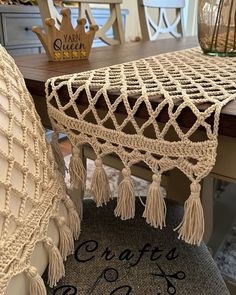 a close up of a chair with tassels on it