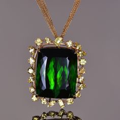 112.97 ct green Tourmaline with 7.07 cts of yellow Sapphires beautifully mounted in 18K gold. Luxury Gold Tsavorite Necklaces, Yellow Sapphire Pendant, Engagement Rings Bands, Rings Bands, Custom Engagement Rings, Sapphire Pendant, Yellow Sapphire, Gorgeous Jewelry, Green Tourmaline