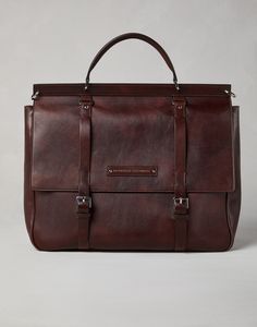 Calfskin casual briefcase The excellence of Brunello Cucinelli leathers defines the sophisticated and retro-inspired style of this calfskin Casual briefcase. The material’s natural grain and its uneven coloration make each piece unique. The large flap closure with adjustable buckles protects the accessory, which features small pockets and three expandable compartments, ideal for storing documents, a laptop, a tablet and all the essentials. Holdall Bag, Brown Accessories, Men's Totes, Latest Bags, Briefcase For Men, Eyewear Womens, Purple Leather, Boutique Online, Purple Bags