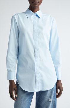 This button-up is cut with a split back yoke, creating a fuller, more modern fit to go with the entrancing exit view in this style. 30" length (size 4) Hidden-button placket; back one-button closure Spread collar Long sleeves with button cuffs Curved hem 100% cotton Dry clean Made in the USA Designer Clothing Classic Blue Blouse With Shirttail Hem, Modern Blue Blouse For Office, Modern Blue Button-up Blouse, Modern Fitted Blouse With Shirttail Hem, Business Casual Shirt With Concealed Placket, Elegant Blue Blouse With Shirttail Hem, Elegant Blue Tops With Shirttail Hem, Fitted Blouse With Shirttail Hem And Placket, Brandon Maxwell