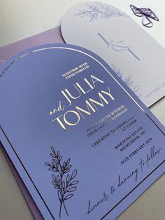 the wedding stationery is designed to look like it has been folded in purple and gold