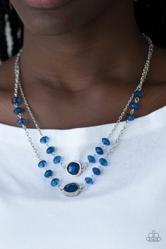 Featuring glassy and gem-like finishes, faceted blue beads trickle along two shimmery silver chains below the collar. Glittery blue rhinestone frames dot the center of the chains for a glamorous finish. Features an adjustable clasp closure. Sold as one individual necklace. Includes one pair of matching earrings. Paparazzi Accessories Elegant Blue Beaded Necklaces With Chain, Elegant Blue Crystal Necklaces With Adjustable Chain, Elegant Blue Crystal Necklace With Adjustable Chain, Silver Crystal Necklace For Party, Silver Glass Crystal Necklaces For Parties, Silver Glass Crystal Necklace For Party, Blue Glass Necklaces With Adjustable Chain, Blue Beaded Necklaces With Chain, Sapphire Rhinestone Party Necklace