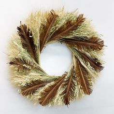 a wreath made out of dried grass and feathers