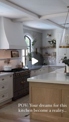 a kitchen with white cabinets and an island in the middle that has potted plants on it