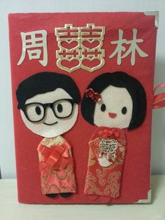 a red book with two dolls on it