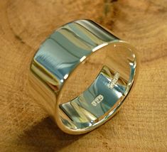 a silver ring sitting on top of a wooden table