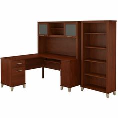 an office desk with bookcases and drawers