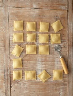 small square pieces of ravioli on a wooden surface