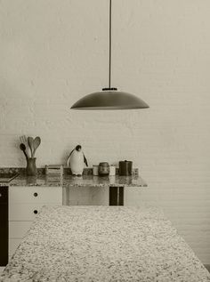 a black and white photo of an island in a kitchen