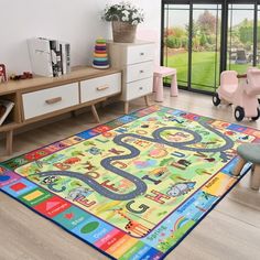 a child's play room with toys and rugs on the floor in front of sliding glass doors