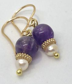 Find your everyday fancy with amethyst and pearl earrings Gold Natural Stones Drop Pearl Earrings, Handmade 14k Gold Filled Pearl Earrings For Anniversary, Gold Pearl Earrings With Natural Stones, Gold Dangle Pearl Earrings With Natural Stones, Gold Pearl Gemstone Earrings For Anniversary, Gold Amethyst Dainty Earrings, Dainty Gold Amethyst Earrings, Handmade Amethyst Gold Earrings, Handmade Gold Amethyst Earrings