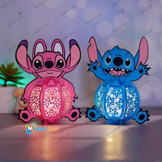 two colorful paper lanterns sitting on top of a table