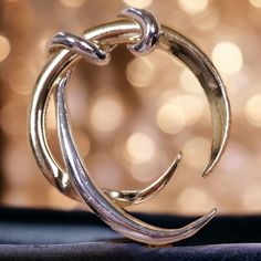 Embrace the celestial elegance with this Sleek Vintage Silver-Tone Crescent Brooch, a piece that beautifully encapsulates the minimalist and modernist design ethos. Its smooth, curved lines and polished surface reflect the sleek sophistication of mid-century modern jewelry, making it a timeless addition to any wardrobe. The brooch is shaped in the form of a crescent, offering a subtle yet powerful symbol of femininity and mystique associated with lunar imagery. Its silver-tone finish provides a Modern Formal Jewelry Brooch, Gold Crescent Brooch Jewelry, Mid Century Modern Jewelry, Cosmic Jewelry, Lunar Jewelry, Space Jewelry, Modernist Design, Amethyst Color, Curved Lines