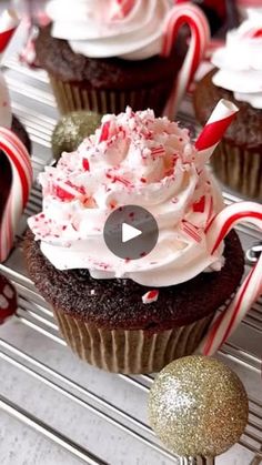 cupcakes with white frosting and candy canes