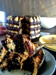 a piece of cake on a plate with a fork in it and another slice missing