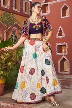 Celebrate the spirit of Navratri in style with our Lehenga Choli with Jacket ensemble, designed to make you stand out during the festive season! This elegant readymade outfit features a stunning combination of Viscose Rayon for the top and jacket, ensuring both comfort and a luxurious drape. The Art Silk lehenga offers a beautiful flow, perfect for twirling on the Garba dance floor. The intricate embroidery work on the waist belt and charming latkan details add a touch of sophistication, while t Anarkali Suits Designer, Garba Outfit, Navratri Lehenga, Purple Lehenga, Vibrant Outfits, Navratri Chaniya Choli, Bollywood Lehenga, Party Wear Gown, Lengha Choli