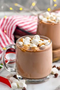 two mugs filled with hot chocolate and marshmallows