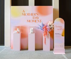 there are three vases with flowers in them next to a mother's day sign