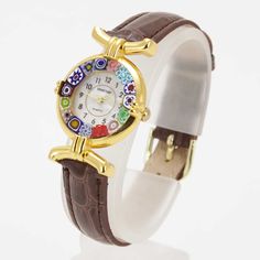 This elegant Murano Glass watch stands out with its combination of high-quality workmanship and inimitable Venetian style. To craft the dial of this watch the artisans used the most famous Murano technique- Millefiori (a thousand flowers)- which has become a worldwide symbol of exquisite Murano craftsmanship. Stylized flowers in a splash of rich colors grace the hand-made face of this watch and give it a trendy Venetian look. This Murano watch adds a perfect accent to any wardrobe and works equa Multicolor Analog Watches As Gift, Multicolor Analog Watches For Gift, Gift Multicolor Analog Watches, Luxury Multicolor Watches For Gift, Luxury Multicolor Watches For Gifts, Luxury Multicolor Watches As Gift, Brown Elegant Watch With Skeleton Dial, Elegant Brown Analog Watch, Elegant Brown Watch With Skeleton Dial