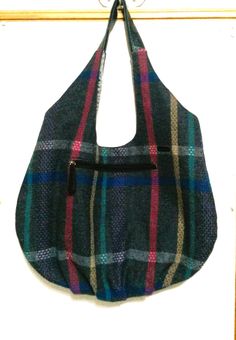 Large hobo bag with boho colors and features is 13.5" high at center of bag above the outside zipper by 21" wide at its widest point. The bag is made of gray tweed plaid.  Colors are gray, pink, blue, purple and teal. There are 2 zipper pockets; one exterior and one interior.  The recycled handle fits the purse perfectly.  Bag is made from the Diana Tote Bag Pattern by Delinda Boutique. Lining is gray taffeta. Use for book bag, knitting or crochet bag, lunch bag, gift bag, shopping bag, everyday bag or whatever you need it for. Fall Travel Hobo Bag With Zipper Pocket, Bohemian Multicolor Bags For Fall, Bohemian Multicolor Fall Bags, Multicolor Hobo Bag For Travel, Bohemian Multicolor Shoulder Bag With Zipper Pocket, Boho Colors, Large Hobo Bag, Bag Knitting, Purple And Teal