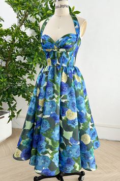 Indulge in luxury with our Corset Blue Green Floral Print Satin Dress. The delicate tie straps and beautiful floral design add a touch of elegance to this exclusive piece. Made with premium satin, this dress is perfect for any high-end occasion. Elevate your fashion game with this sophisticated dress. Bust and Skirt with full lining. 100% Polyester 100% Recycled polyester lining Concealed zip at centre back Imported Print Satin Dress, Printed Satin Dress, Floral Pattern Dress, Green Floral Print, Fabric Accessories, Sophisticated Dress, 50s Dresses, Blue Floral Print, Tea Length