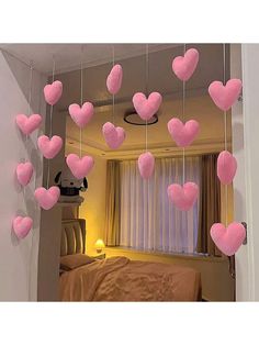 pink hearts hanging from the ceiling in a bedroom