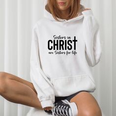 This Sisters in Christ are Sisters for life hoodie is the perfect Christian gift for that special friend in faith. Whether it's a Christmas gift, a Birthday gift, or just a thank you for your friendship, it's sure to warm her heart inside and out. It's soft, cozy, and flattering for women of all ages. Fellowship with other women in faith is such a special bond. There is nothing more powerful than the support and encouragement from prayer warrior Sisters in Christ to lean on each other. As the Bi Christian Hats, Patriotic Outfit, Christian Sweatshirt, Lean On, Prayer Warrior, Special Friend, Christian Clothing, Mens Sweatshirts Hoodie, White Hoodie