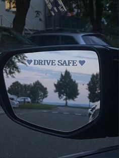 the rear view mirror of a car that says drive safe