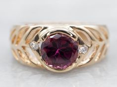 This classic yellow gold rhodolite garnet ring features diamond accents to create a sophisticated look. The genuine gemstone and expertly crafted gold setting provide timeless elegance, perfect for any occasion.Metal: 14K Yellow GoldGem: Rhodolite Garnet ~2.31 Carats Gem Measurements: 7.5 mm, RoundAccents: 2 Diamonds totaling .06 Carats, SI in Clarity, G in ColorRing Size: 9.25Marks: "14K" Stamped on the inside Purple Sapphire Ring, Rhodolite Garnet Ring, Garnet And Diamond Ring, Ring With Diamond, Garnet Ring, Gold Gift, Rhodolite Garnet, Garnet Rings, Color Ring