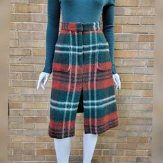 Gorgeous colors on this 60s/70s plaid wool skirt by Junior House.  The fabric is thick wool kind of like a blanket.  Cute style with the front pockets and center split.  Closes with a green 'Talon' brand zipper center front, and two hook and eyes closes the waistband.  There is no lining in the skirt.  100% wool, thick and warm.   Condition - Excellent, with no issues.   Measurements - For reference, the dress form measures W24.5 H35.  Too big on these measurements, and is clipped at the waist and hips to show better fit.     Waist: 28", measures 14 inches across at waistband seam and 14 1/2 inches at top of waistband Hip: 39" measured about 8 inches below waist seam 41" about 10 inches below waist seam.  There is some stretch as the chevron means the fabric is cut on the bias. Length: 25" Blanket Skirt, Wool Plaid Skirt, 70s Plaid, Skirt Winter, Blanket Cute, Plaid Wool Skirt, Thick Wool, Wool Pencil Skirt, Plaid Blanket