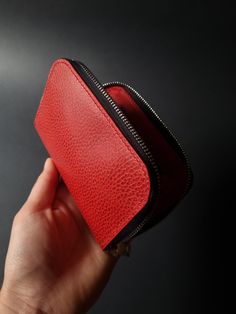 A compact red leather wallet for those who needs something small-size and nice to feel in the hand.  Made of strong temper red Buttero Dollaro leather, this wallet has an embossed yet smooth surtfacr in a grainned patterned achieved by applying heat. The wallet is fully HANDSTITCHED. The interior, including the coint compartment and gussets, is made of a matching plain Buttero leather. A different color lining is possible. Feel free to get in touch for more detailed information. VEGETABLE TANNED LEATHER The wallet is made of vegetable tanned leather, which is widely acknowledged by leather crafted. Even it is is embossed, thus having a firm surface, this leather ages gracefully and builds its unique patina, which depends on the way it was carried and cared for by the user. This leather is Red Vegetables, Leather Zipper Wallet, Red Wallet, Money Clip Wallet, Zipper Wallet, Leather Wristlet, Leather Zipper, Vegetable Tanned Leather, Leather Craft