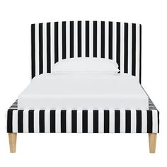 a bed with black and white striped headboard on it's side, against a white background