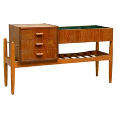 a wooden desk with drawers and a glass top on it's side table is shown against a white background