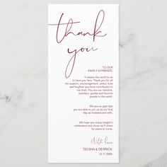 a thank card with the words, thank you in red ink on white paper next to a marble surface