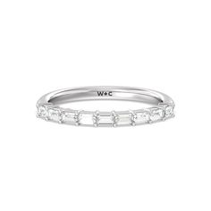 a white gold wedding band with baguettes on the side and inscription wcc