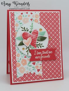 a close up of a card with flowers and hearts on the front, in red and white