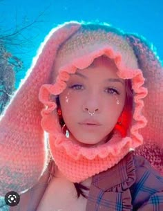 a woman wearing a pink hat and scarf